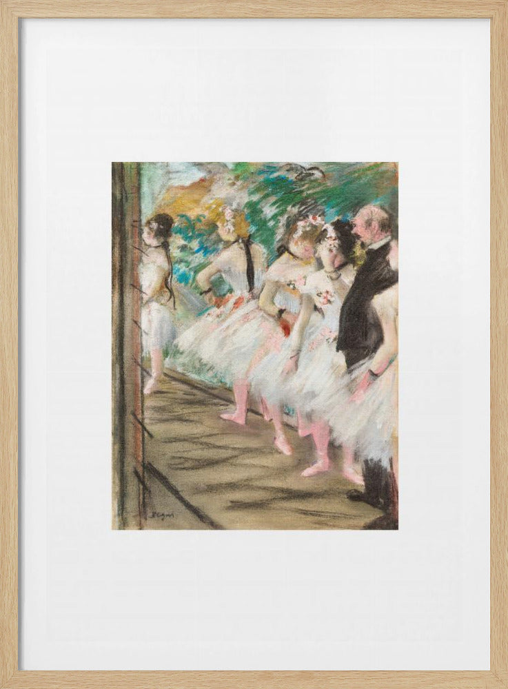 An Impressionist painting by Edgar Degas showing a group of ballet dancers in white tutus waiting in the wings of a stage. A man in a dark suit stands with them. The artwork is presented in a black frame with a white mat. Print