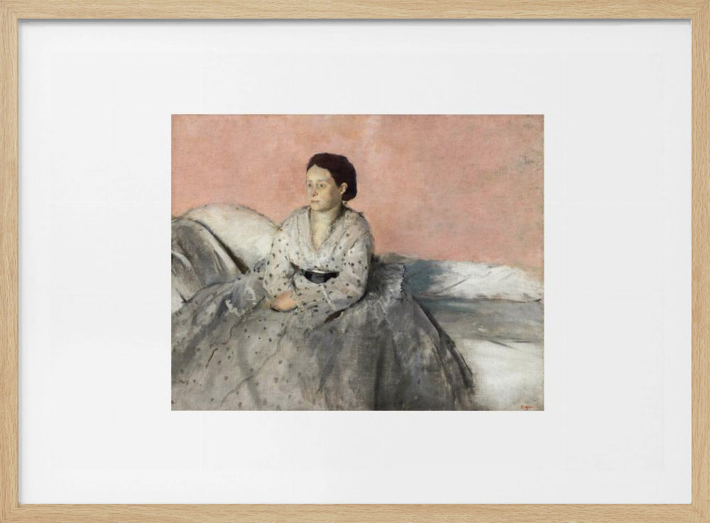 A framed impressionist painting of a woman with dark hair sitting on a bed against a dusty rose background. She wears a white, dotted blouse and a voluminous gray skirt, looking thoughtfully to her left. The painting is set in a silver frame with a white mat. Poster