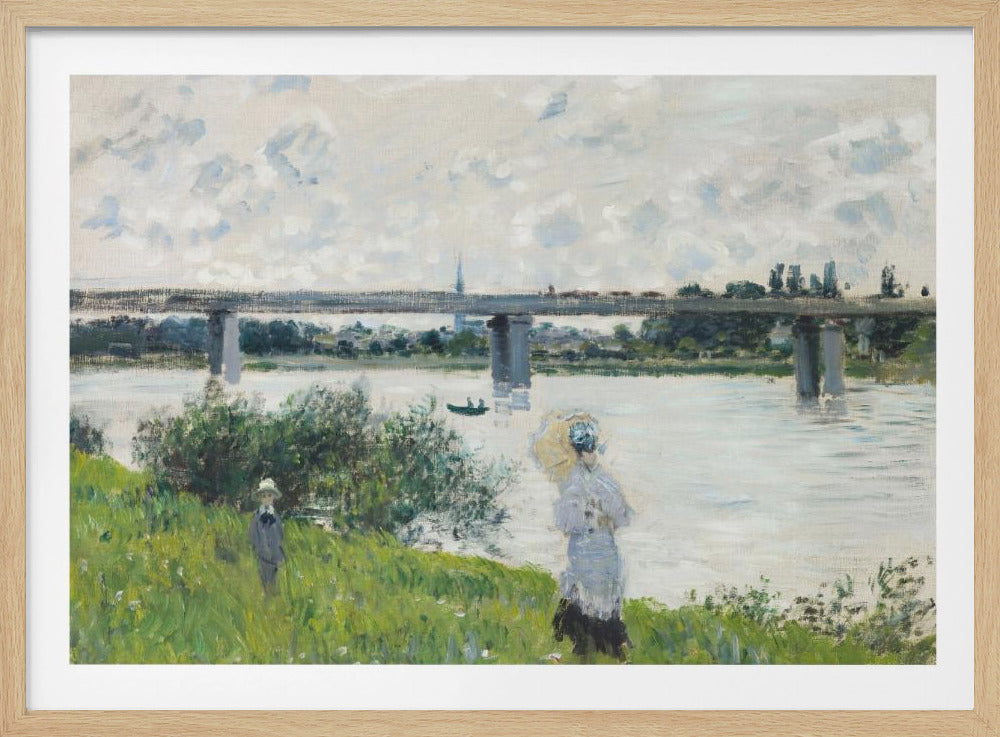 A scenic landscape art print by Claude Monet titled 'The Promenade With the Railroad Bridge, Argenteuil', depicting people on a promenade alongside a body of water with a railroad bridge in the background, characteristic of Impressionist style with soft colors and brushstrokes. Print