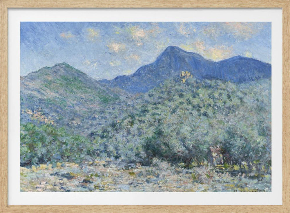 An Impressionist painting by Claude Monet, 'Valle Buona, near Bordighera', showcasing a vast landscape of rolling green hills and deep blue mountains under a light blue sky with wispy clouds. The painting, rendered in soft, textured brushstrokes, is presented in a simple silver frame. Print
