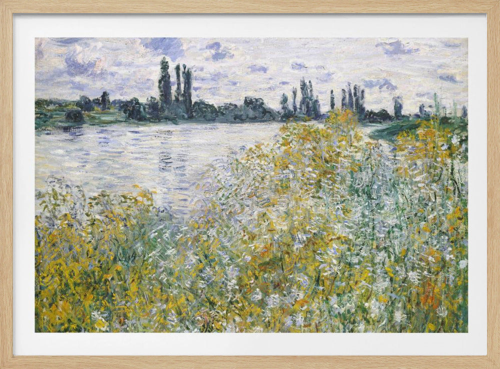 An impressionist landscape painting of a riverbank covered in yellow and white wildflowers. A calm river reflects the cloudy sky, and the opposite bank is lined with tall, dark poplar trees. The artwork is displayed in a silver frame. Artwork