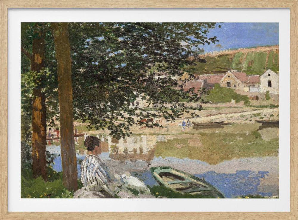 An impressionist painting of a woman in a striped top sitting on a grassy riverbank under a large tree. A green rowboat is nearby, and across the water is a small village with its reflection visible in the river. Poster