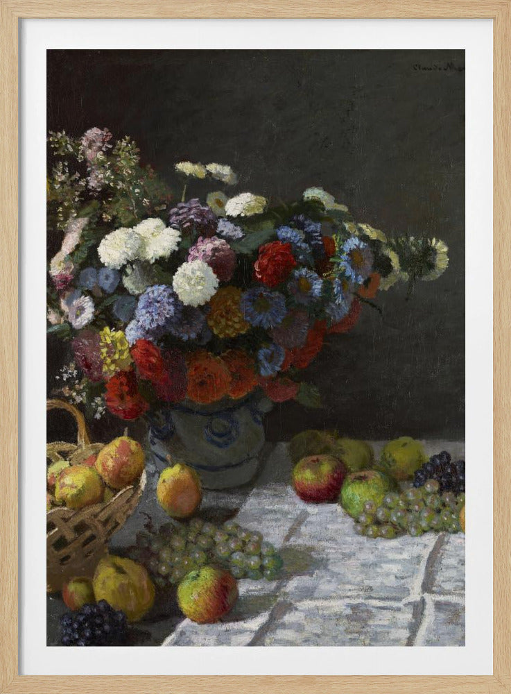 A classic still life painting by Claude Monet depicting a vibrant, multicolored bouquet of flowers in a ceramic vase. Scattered around the vase on a white tablecloth are various fruits, including apples, pears in a basket, and bunches of grapes, all set against a dark, moody background. Poster