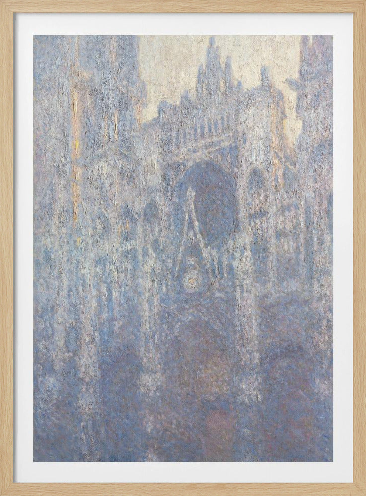 An Impressionist painting by Claude Monet depicting the Rouen Cathedral. The view is a close-up of the facade, rendered in hazy, textured brushstrokes with a predominantly blue, gray, and pale yellow color palette, suggesting early morning light or fog. The painting is enclosed in a simple black frame. Artwork