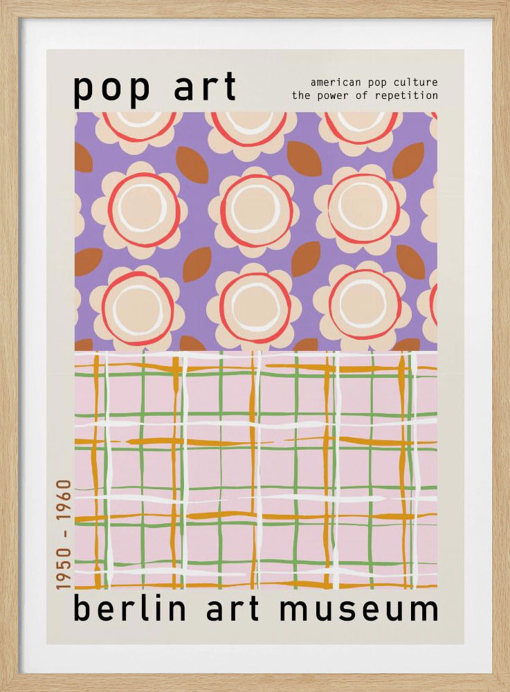 A framed pop art museum poster advertising an exhibition at the Berlin Art Museum. The poster features two distinct patterns. The top section has repeating stylized cream and red flowers on a purple background, with the words 'pop art' and 'american pop culture the power of repetition'. The bottom section displays a pink, green, and orange plaid pattern. The dates '1950 - 1960' are printed vertically on the side. Artwork