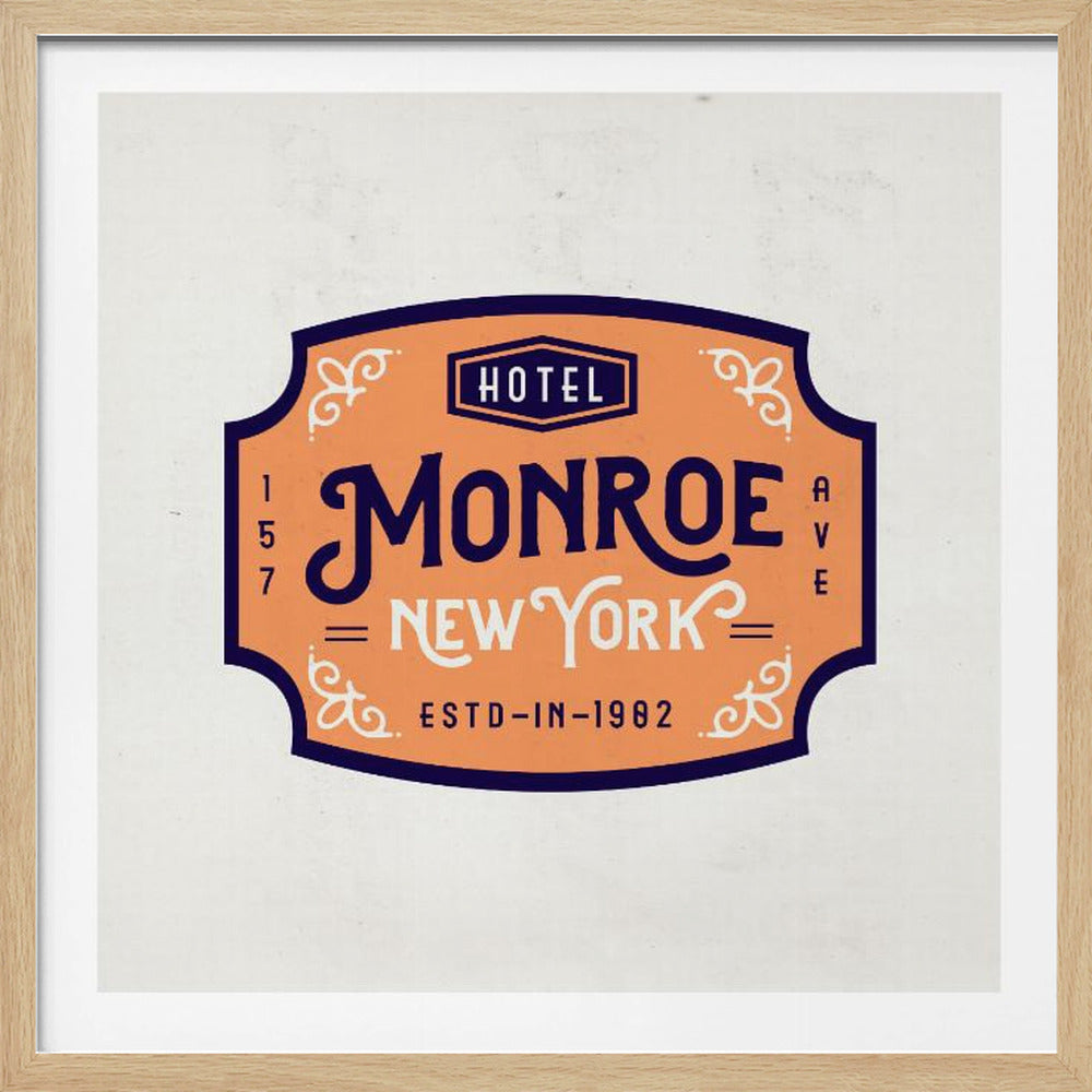 A vintage-style art print of a hotel sign for the 'Monroe Hotel' in New York, framed in light wood. The sign has an ornate shape, an orange background, and dark blue and cream typography with decorative flourishes. It reads 'HOTEL MONROE NEW YORK' and 'ESTD-IN-1982'. Wall Art