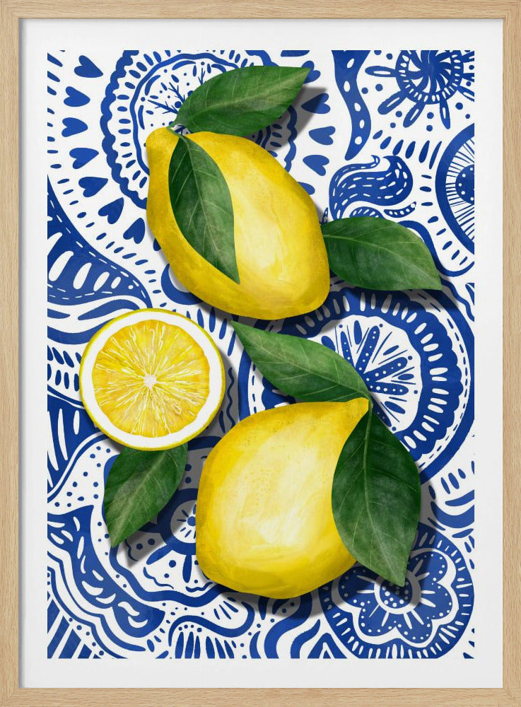A vibrant art piece featuring two whole lemons and one lemon slice with green leaves, arranged on a detailed blue and white patterned background that resembles Mediterranean tiles. The lemons are brightly colored and cast a slight shadow, creating a sense of depth. Wall Art