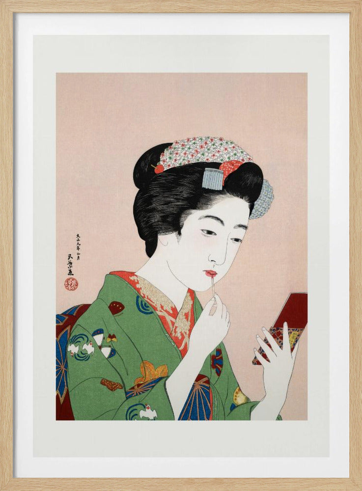 A Japanese ukiyo-e woodblock print of a woman in a green kimono applying red lipstick while looking into a small handheld mirror. Her black hair is elaborately styled, and the background is a soft pink. Artwork