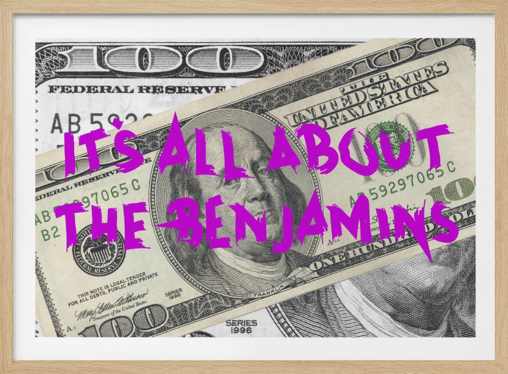 A pop art piece featuring a close-up of a one-hundred-dollar bill. The phrase 'IT'S ALL ABOUT THE BENJAMINS' is written across the image in a messy, graffiti-style font in a vibrant magenta color. The artwork is set within a silver frame. Wall Art