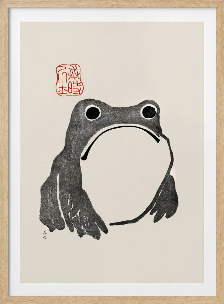 A minimalist Japanese-style ink wash painting of a stylized frog with a grumpy expression. The frog is rendered in black ink on a cream-colored paper, with a large white throat pouch. A red artist's seal is stamped above the frog's head. The artwork is presented in a simple black frame. Artwork