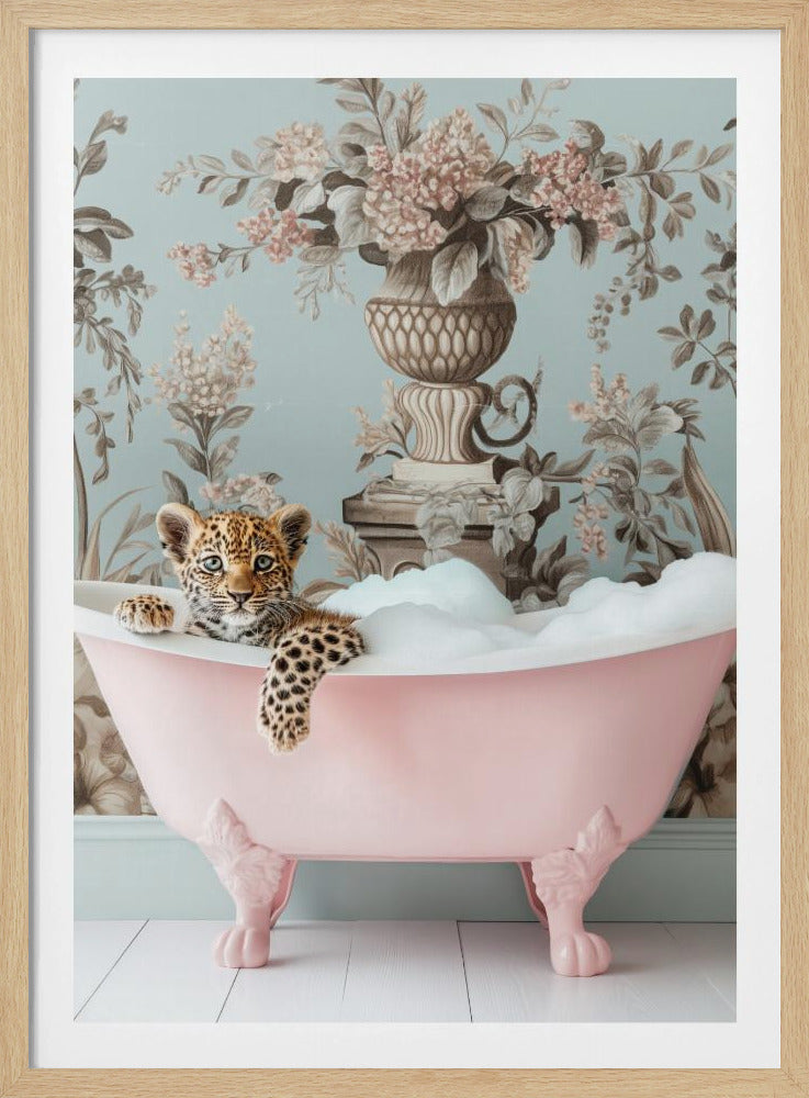 A whimsical portrait of a baby leopard cub relaxing in a pink clawfoot bathtub filled with bubbles. The cub looks directly at the viewer with its paw resting on the edge of the tub. The background features a vintage-style light blue wallpaper with a brown and pink floral pattern. Artwork