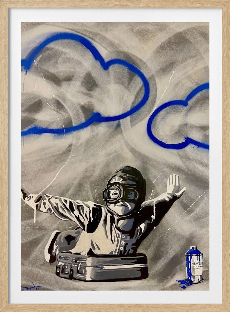 A framed street art style painting featuring a grayscale figure in an aviator helmet and goggles emerging from a briefcase with arms outstretched. The background is a swirling mix of grey and white, with two large clouds outlined in vibrant blue spray paint. In the bottom right, a spray paint can with blue drips is labeled 'IN HEAVEN there is no Pain'. Wall Art