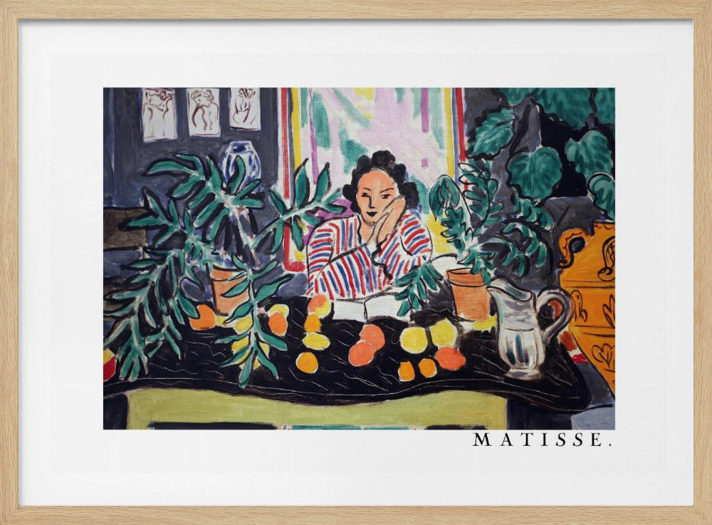 A framed print of the painting 'Woman with a Book' by Henri Matisse. The artwork features a woman in a red, white, and blue striped shirt sitting at a dark table filled with potted green plants and colorful fruit. She rests her head on her hand, looking out from the painting in a Fauvist style with bold colors and expressive brushwork. Poster