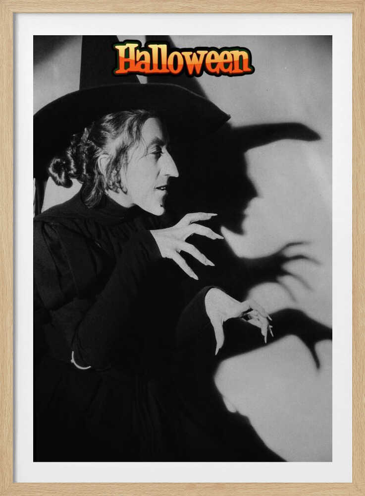A vintage black and white poster for Halloween featuring a classic witch character. She is in profile, wearing a large pointy hat and a black gown, with long, sharp fingernails. Her menacing shadow is cast on the wall behind her, mirroring her posture. At the top of the image, the word 'Halloween' is written in a stylized orange and yellow font. Decor