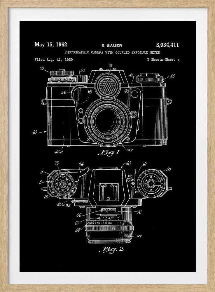 A framed patent illustration of a photographic camera from 1962, presented as a white line drawing on a black background. The poster shows two figures: Fig. 1 is a front view of the camera, and Fig. 2 is a top-down view. Both diagrams are detailed with numbers and lines pointing to various components. The top of the poster includes text with the patent date, inventor's name (E. Sauer), and patent number. Poster