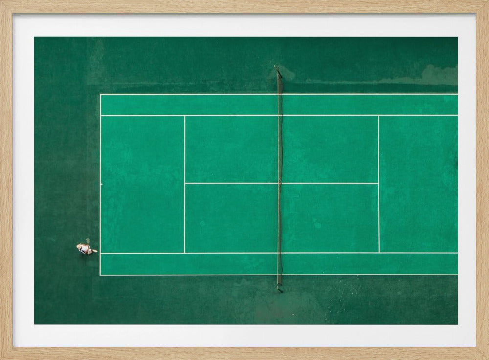 An aerial top-down photograph of a vibrant green tennis court with two players in the middle of a game, one on the far left and the other on the far right, all enclosed within a brushed silver frame. Print