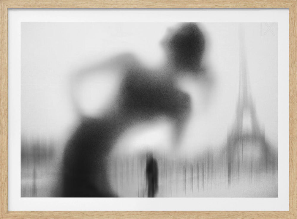 A framed, black and white abstract photograph featuring the blurry, grainy silhouette of a woman leaning forward. In the misty background, the faint outline of the Eiffel Tower and a smaller, distant figure are visible, creating a moody and mysterious Parisian scene. Wall Art