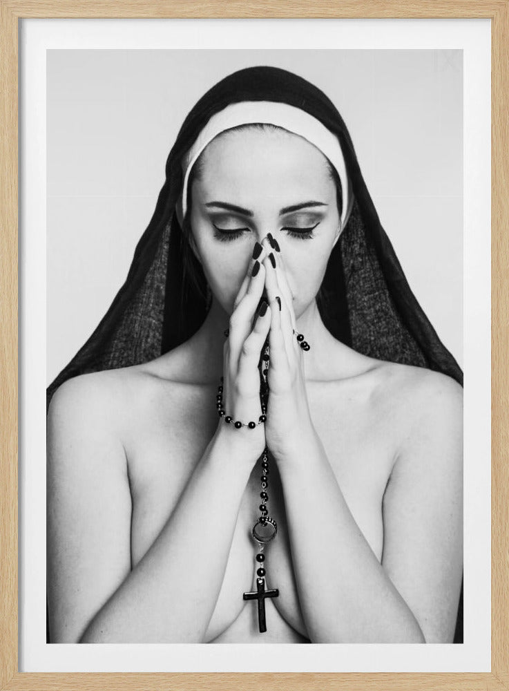 A black and white portrait of a woman with dramatic eye makeup wearing a nun's habit. Her eyes are closed and her hands are clasped in front of her face in prayer, holding a black rosary. Her shoulders are bare, creating a stark contrast. Artwork
