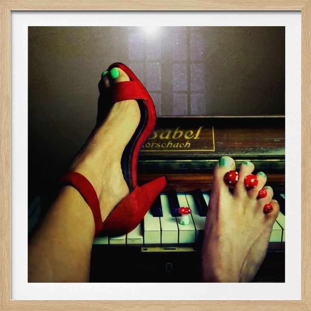 A surreal close-up of two feet on piano keys, one in a bright red high-heel with green toenails, the other bare with tiny decorative red and white mushrooms between its green-polished toes. Poster