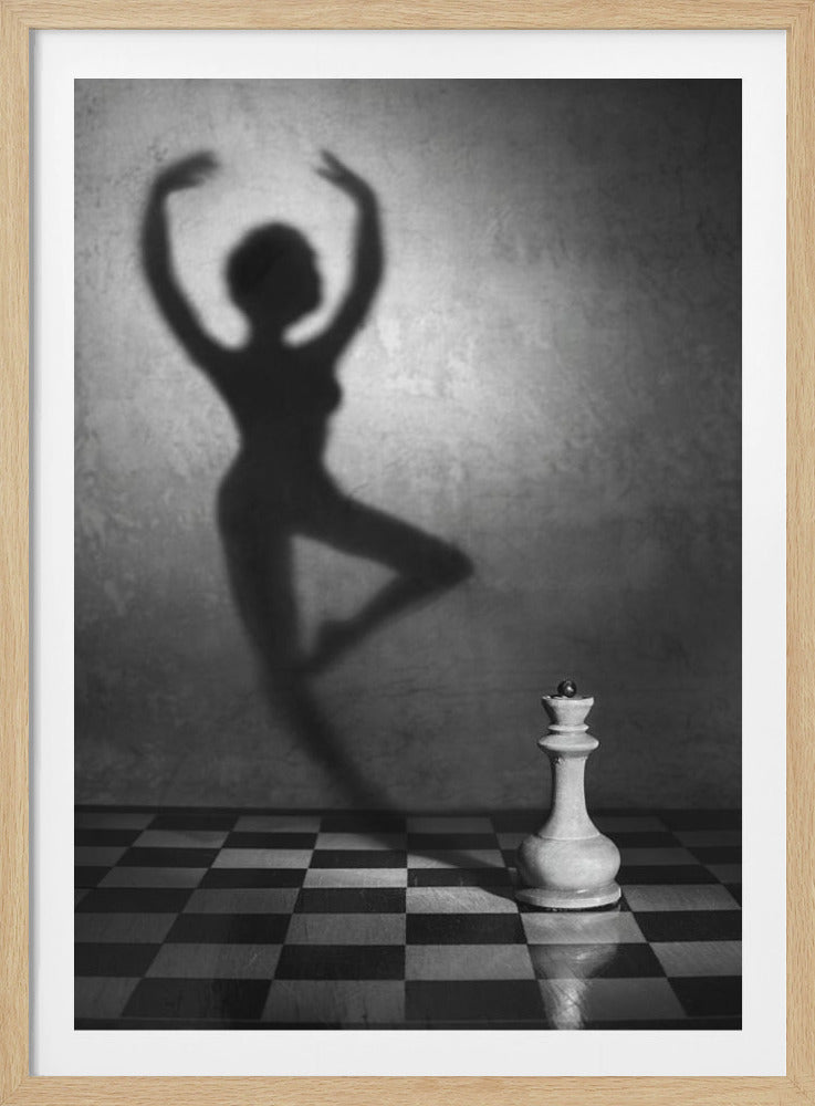 A surreal black and white photograph featuring a white queen chess piece on a checkered board, casting a large, soft shadow of a gracefully dancing woman on the wall behind it. Poster