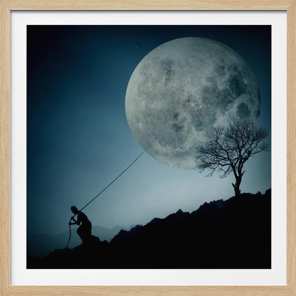 A surreal, framed artwork depicting a silhouette of a person on a dark, rocky hill at night, pulling a rope attached to a massive, detailed full moon, seemingly trying to pull it from the dark blue, star-dusted sky. A bare, silhouetted tree stands on the same hill. Artwork