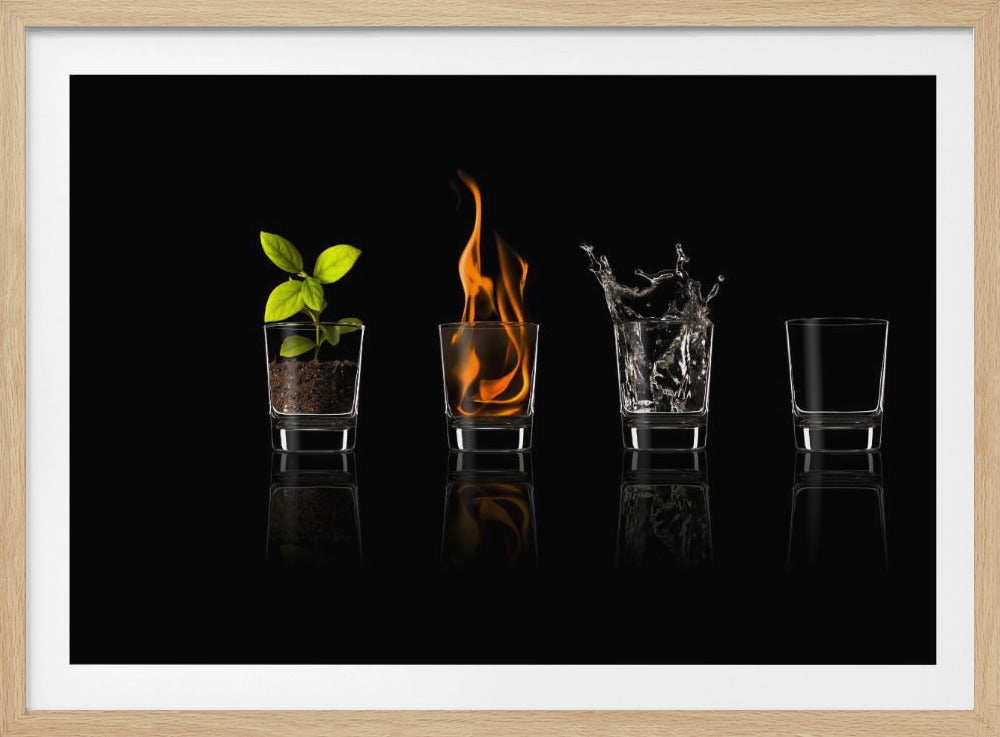 A conceptual art piece displaying the four classical elements in a row of four glasses against a black background, with a silver frame. The glasses represent earth with a plant in soil, fire with flames, water splashing, and air as an empty glass, with reflections below. Decor