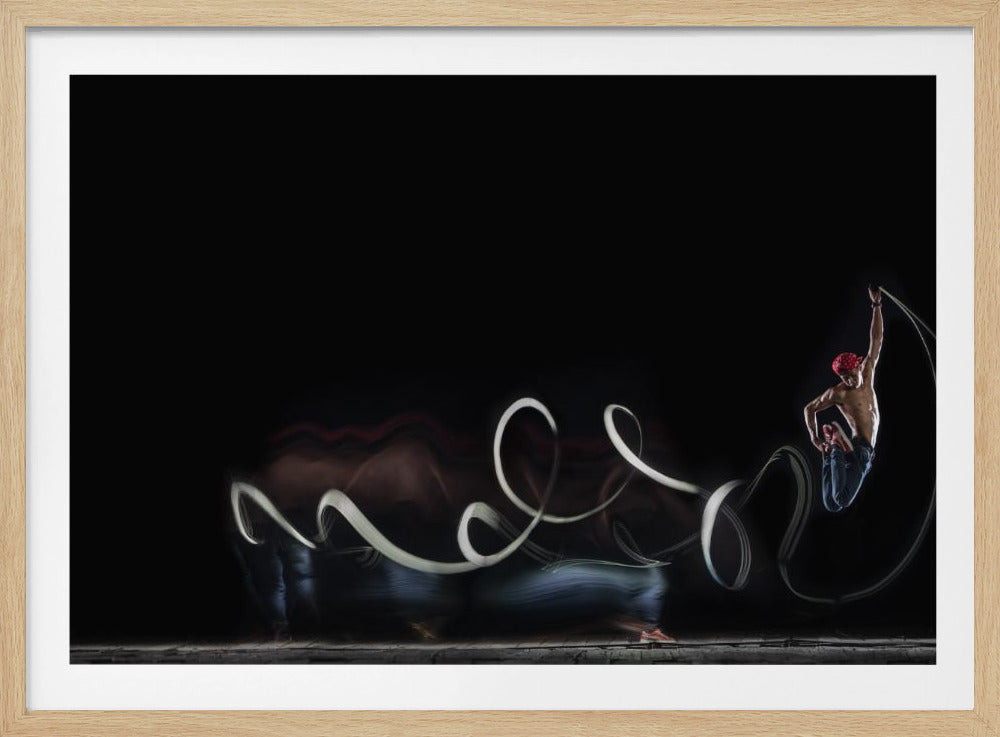 A dynamic long-exposure photograph showing a swirling white light trail against a black background, culminating in a muscular man in a red bandana frozen mid-jump at the end of the trail. Poster