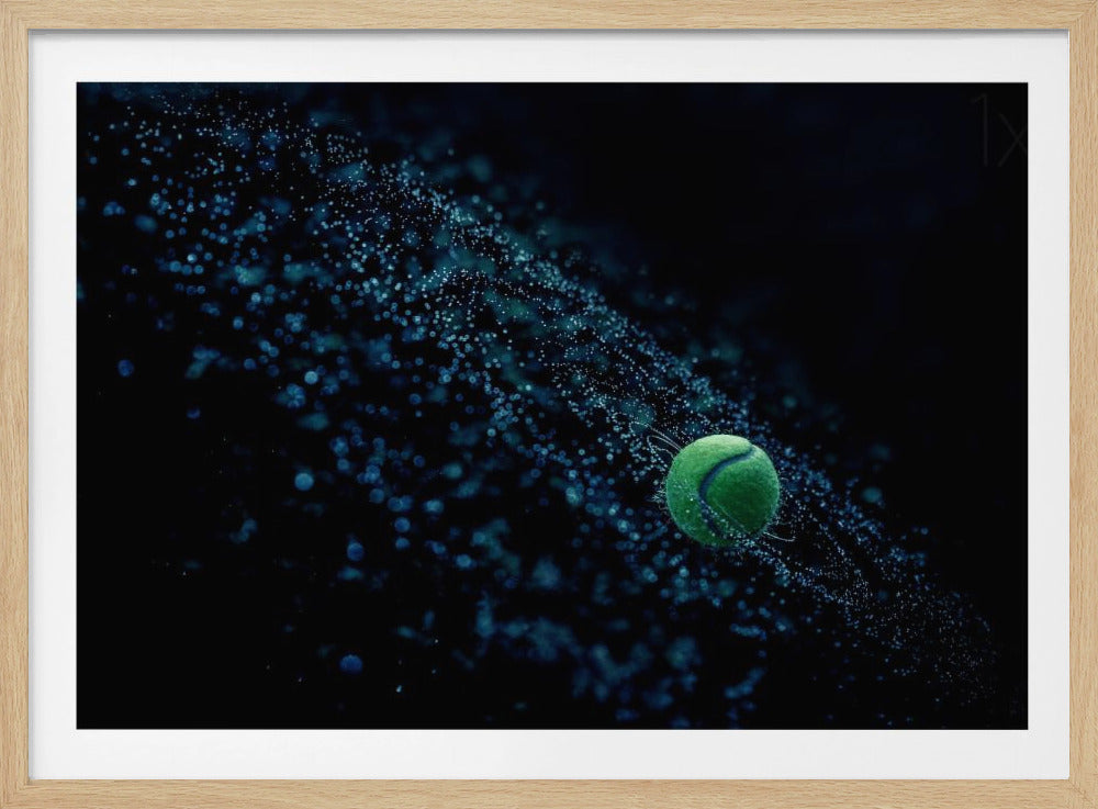 A high-speed photograph captures a spinning green tennis ball against a black background, with a dramatic spray of blue-lit water droplets flying off it in a cosmic-like spiral. Artwork