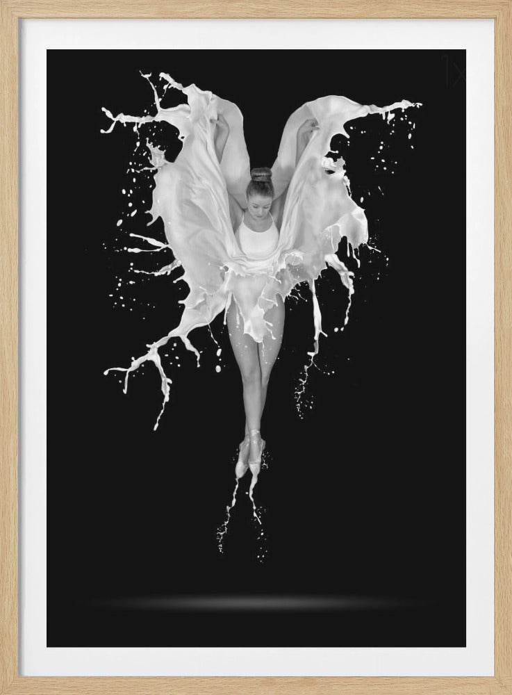 A dramatic black and white photograph of a ballerina suspended in mid-air against a black background. She is en pointe, and a dynamic splash of white liquid surrounds her, creating the illusion of wings. Artwork