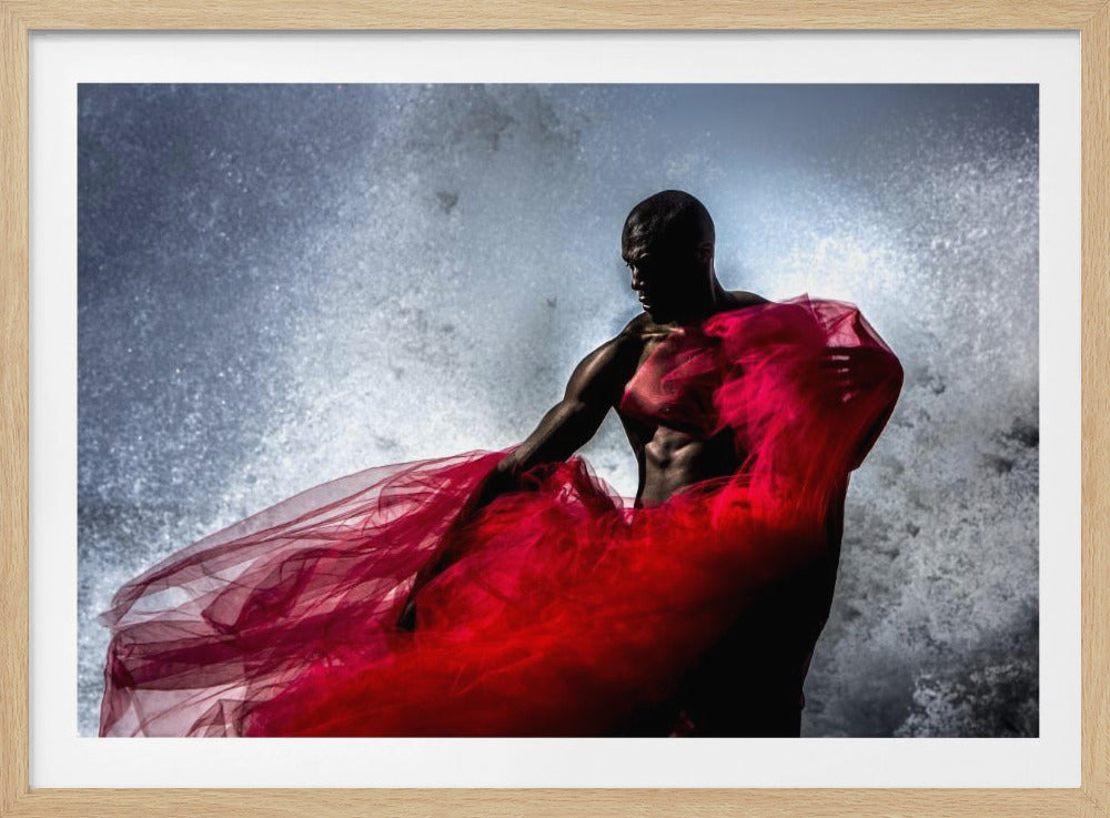 A dramatic photograph of a muscular Black man, mostly in shadow, holding a voluminous, sheer red fabric against a backdrop of splashing white water. The image is encased in a silver frame. Poster