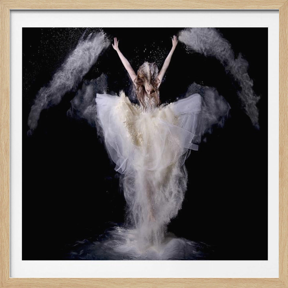 A framed studio photograph of a woman in an elegant, flowing white gown against a solid black background. Her arms are raised triumphantly as she throws clouds of white powder into the air, which billow around her in dramatic plumes. The powder also surrounds her lower body, rising from a dark, reflective floor, creating a magical and ethereal scene. Print