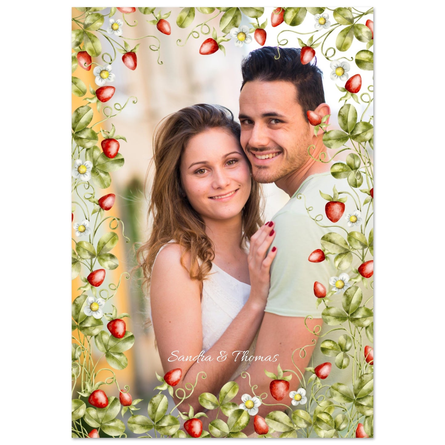 A smiling couple, a man and a woman, posing for a photo. The image is framed by a watercolor illustration of strawberry vines with green leaves, red strawberries, and small white flowers. At the bottom of the photo, the names 'Sandra & Thomas' are written in a cursive script. Wall Art