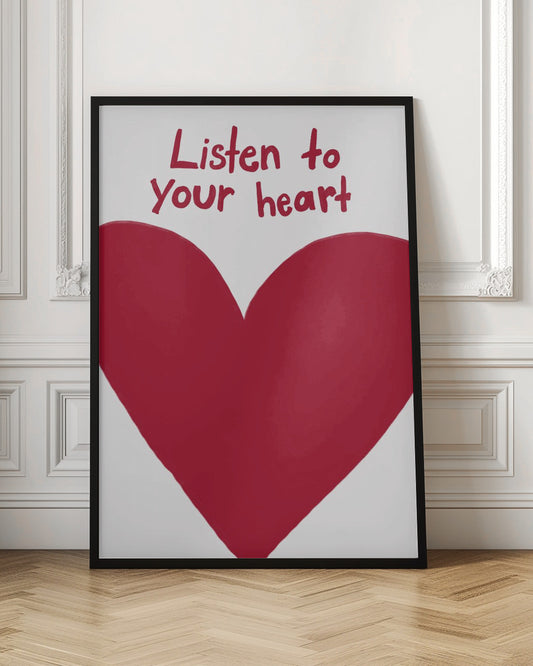 A framed art print with a large, imperfectly drawn red heart on a white background. Above the heart, the phrase 'Listen to your heart' is written in a casual, red handwritten font. Wall Art