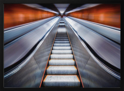 A symmetrical, low-angle photograph looking up a very long escalator, creating a strong sense of perspective towards a vanishing point. The orange walls are motion-blurred, suggesting speed, while the metallic steps in the center remain clear. Decor