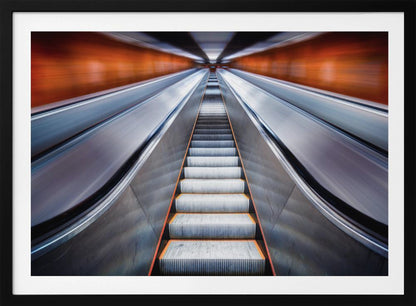 A symmetrical, low-angle photograph looking up a very long escalator, creating a strong sense of perspective towards a vanishing point. The orange walls are motion-blurred, suggesting speed, while the metallic steps in the center remain clear. Decor