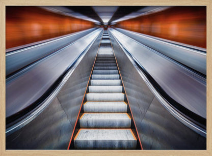 A symmetrical, low-angle photograph looking up a very long escalator, creating a strong sense of perspective towards a vanishing point. The orange walls are motion-blurred, suggesting speed, while the metallic steps in the center remain clear. Decor