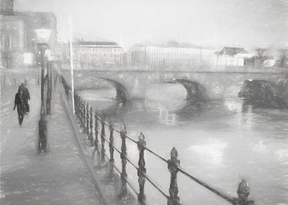A framed, black and white impressionistic artwork of a city scene on a foggy or rainy day. In the foreground, a dark metal railing runs along a riverside walkway where a person in a dark coat is walking. An arched stone bridge crosses the river in the midground, with hazy buildings visible in the background, creating a moody and atmospheric scene. Wall Art