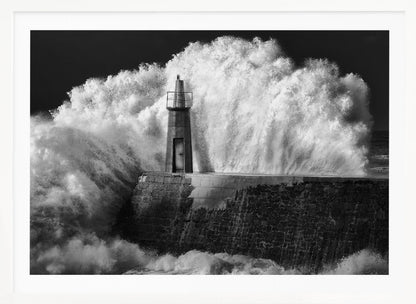 A dramatic black and white photograph of a massive wave crashing against a stone pier and a small lighthouse. The white foam of the wave towers over the structure, creating a powerful and dynamic scene against a dark sky, all enclosed in a silver frame. Poster