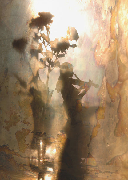 An abstract, dreamlike artwork featuring the dark silhouettes of a person playing the violin and a vase of roses against a bright, textured, and reflective background with warm tones of brown, gold, and bronze. The piece has a weathered, vintage appearance and is set in a thin black frame. Print