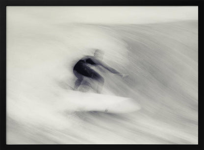 An artistic black and white photograph using motion blur to capture a surfer in a dynamic, fluid pose on a wave. The slow shutter speed creates a sense of speed and abstract movement, with the surfer's dark wetsuit contrasting against the white, streaked water. The image is presented in a silver frame. Decor