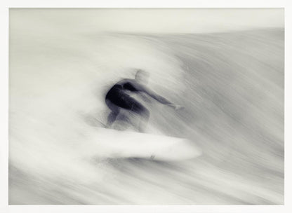 An artistic black and white photograph using motion blur to capture a surfer in a dynamic, fluid pose on a wave. The slow shutter speed creates a sense of speed and abstract movement, with the surfer's dark wetsuit contrasting against the white, streaked water. The image is presented in a silver frame. Decor