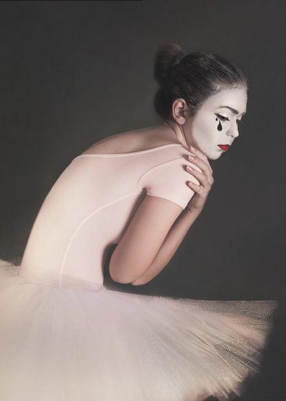 A portrait of a sad ballerina with white mime makeup and a black teardrop painted on her cheek, wearing a pink leotard and white tutu against a dark gray background. Artwork
