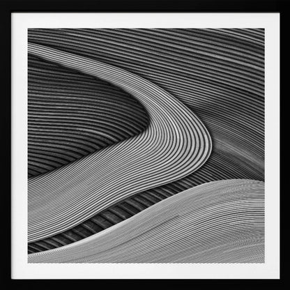 A framed black and white abstract artwork featuring a dynamic composition of flowing, wave-like forms created from dense, parallel lines. Lighter-toned curves sweep across the canvas, overlapping darker areas and creating a sense of depth, texture, and movement. Decor