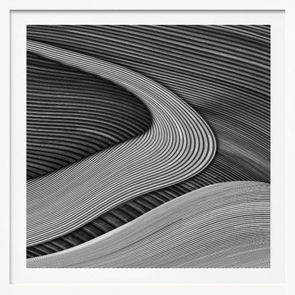 A framed black and white abstract artwork featuring a dynamic composition of flowing, wave-like forms created from dense, parallel lines. Lighter-toned curves sweep across the canvas, overlapping darker areas and creating a sense of depth, texture, and movement. Decor