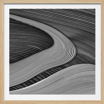 A framed black and white abstract artwork featuring a dynamic composition of flowing, wave-like forms created from dense, parallel lines. Lighter-toned curves sweep across the canvas, overlapping darker areas and creating a sense of depth, texture, and movement. Decor