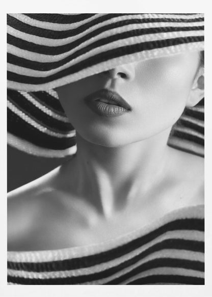 A mysterious black and white close-up portrait of a woman wearing a large, floppy hat with bold black and white stripes. The hat's brim covers her eyes, revealing only her nose, full lips, and chin, creating an elegant and enigmatic look. Decor