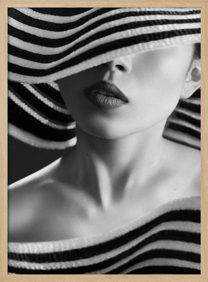 A mysterious black and white close-up portrait of a woman wearing a large, floppy hat with bold black and white stripes. The hat's brim covers her eyes, revealing only her nose, full lips, and chin, creating an elegant and enigmatic look. Decor