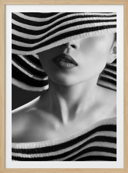 A mysterious black and white close-up portrait of a woman wearing a large, floppy hat with bold black and white stripes. The hat's brim covers her eyes, revealing only her nose, full lips, and chin, creating an elegant and enigmatic look. Decor