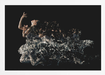 A conceptual piece of artwork depicting a woman in a dynamic pose against a solid black background. Her form appears to be shattering and dissolving into a swirling cloud of broken glass shards, creating a powerful and dramatic effect. The piece is presented within a simple silver frame. Print