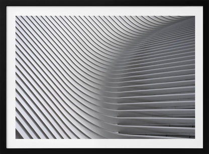 A framed, close-up, abstract photograph of a modern architectural structure. Parallel white ribs curve and undulate across the frame, creating a sense of movement and rhythm through the interplay of light and shadow. Artwork